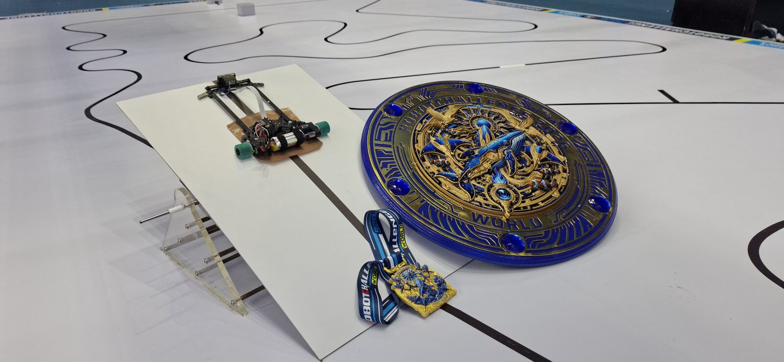 HLR robot with RobotChallenge China 2026 trophy and medal on the track