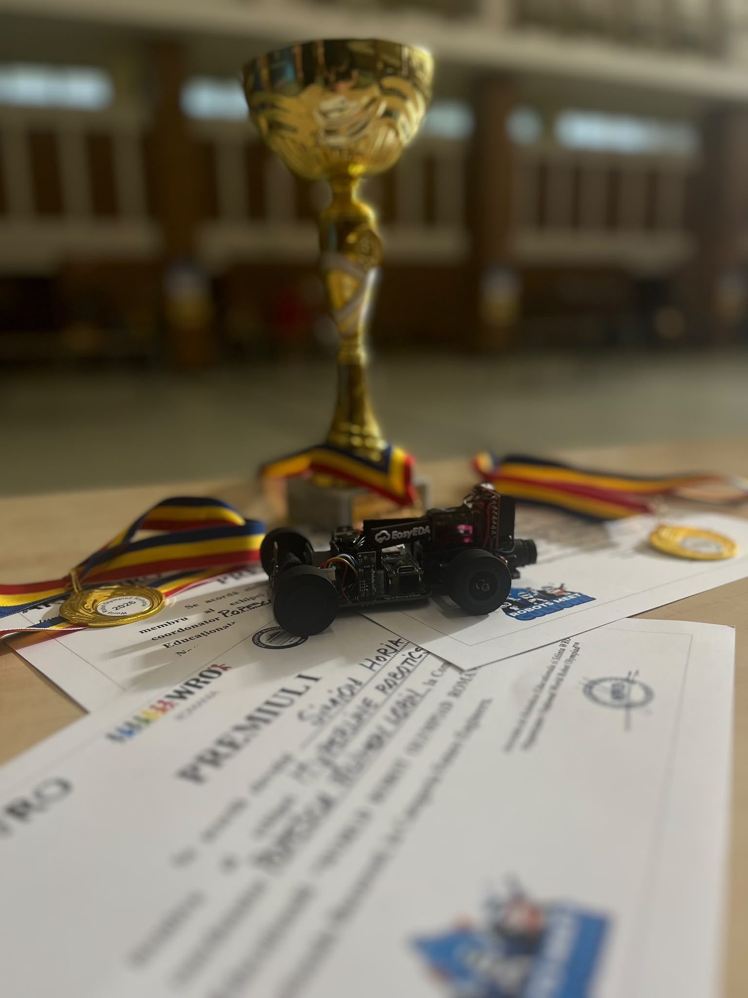 HLR Self-Driving Car V2 with WRO 2026 trophy, medals and certificate
